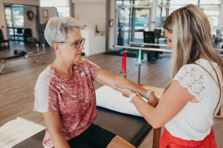 Physical Therapy Session - PT stretching arm and wrist muscles